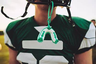 How do you attach a mouthguard to a lacrosse helmet?